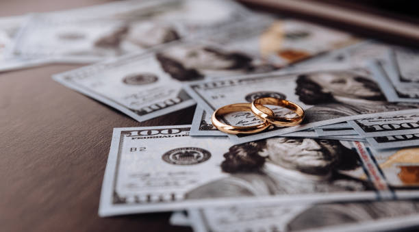 Wedding rings on money background, close up for wedding gift money.