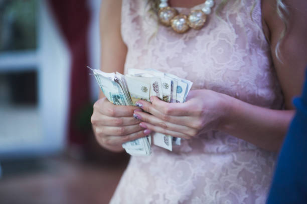 Bride counting wedding gift money.