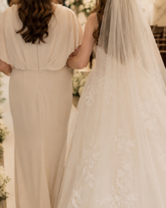 Up close shot of a mother walking her daughter down the aisle on her wedding day,