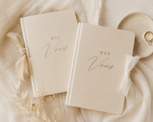 Cream aesthetic image of his and her vow books.